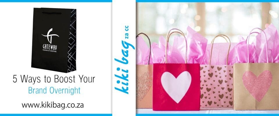 Several pink giftbags covered in hearts await distribution to clients